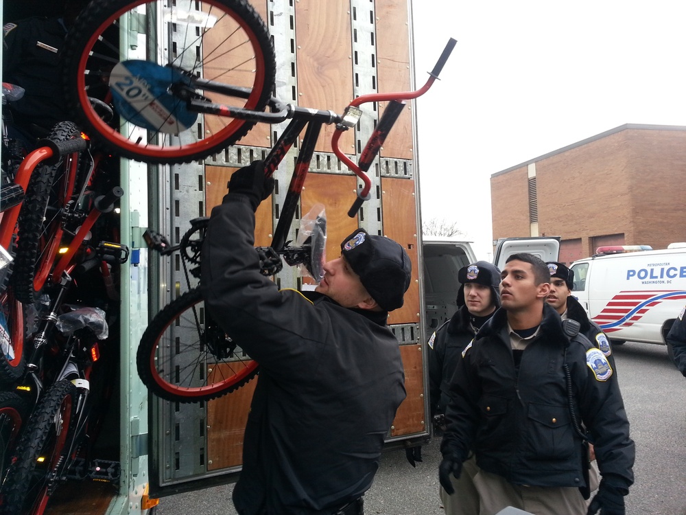 Cadets from the Metropolitan Police Department (MPD) Academy unload bicycles donated to the U.S. Marine Corps Foundation’s Toys for Tots program
