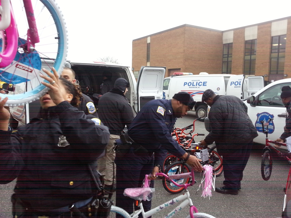 Police officers unload bicycles donated to the Toys for Tots program