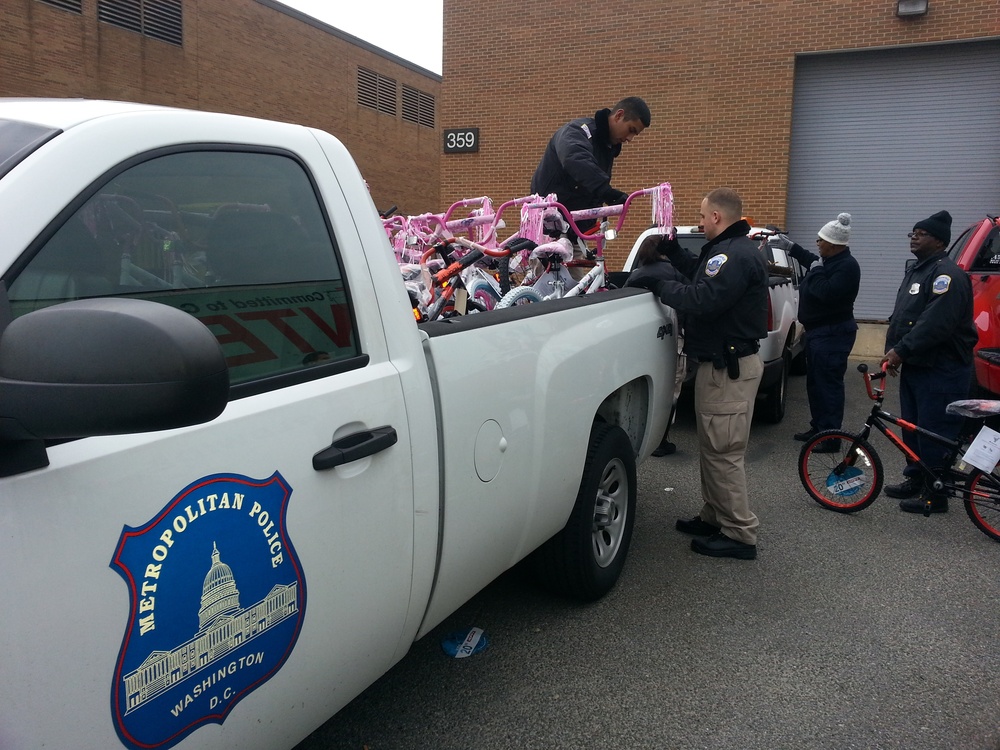 Police officers load bicycles donated to the Toys for Tots program