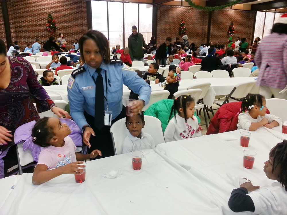Youth at the DC Ward 8/Metropolitan Police Department (MPD) Seventh District holiday party for underprivileged children look up to a Cadet from the MPD Police Academy