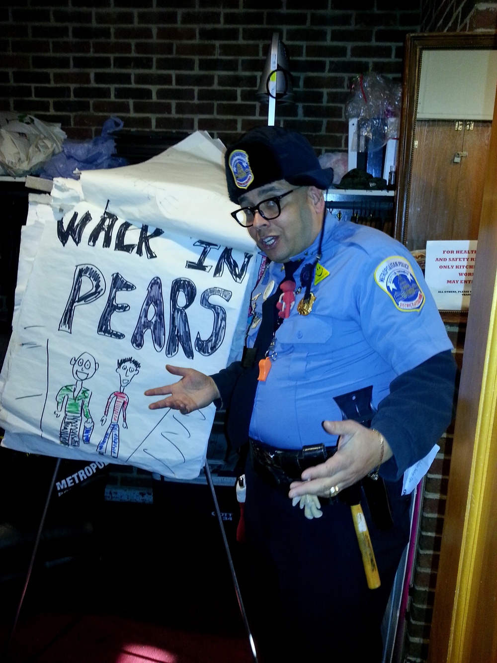 Metropolitan Police Department (MPD) safety outreach officer teaches holiday safety tips; encourages youth to walk in pears [sic]