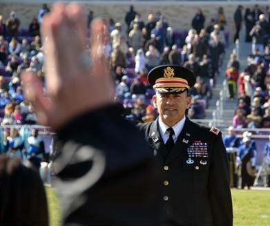 Army Col. Fabian Mendoza Jr. gives oath of enlistment to new recruits at Armed Forces Bowl 2013