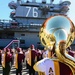 Arizona State University marching band performs in front of USS Ronald Reagan