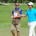 Service members caddy for professional golfers during Pro-Am event