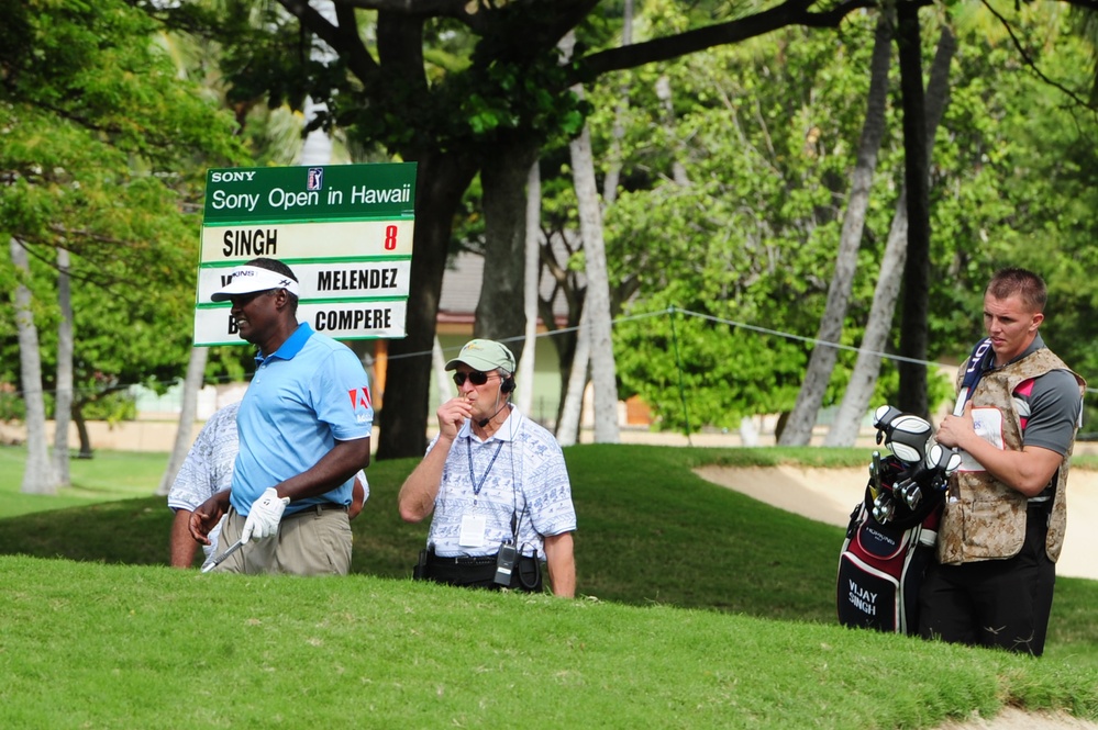 Service members caddy for professional golfers during Pro-Am event