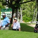 Service members caddy for professional golfers during Pro-Am event