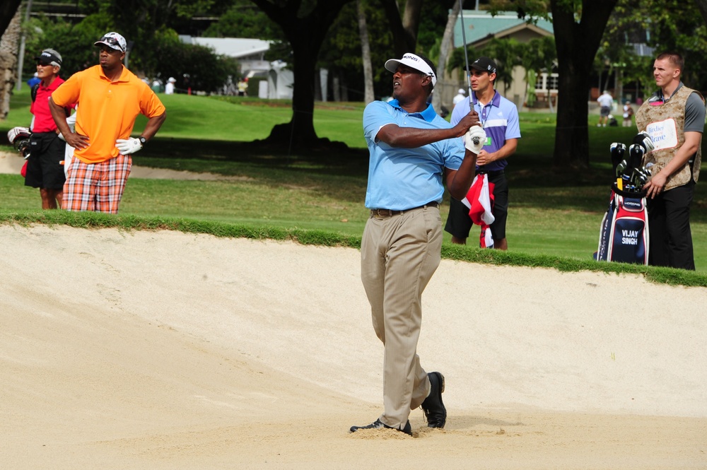 Service members caddy for professional golfers during Pro-Am event