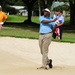 Service members caddy for professional golfers during Pro-Am event