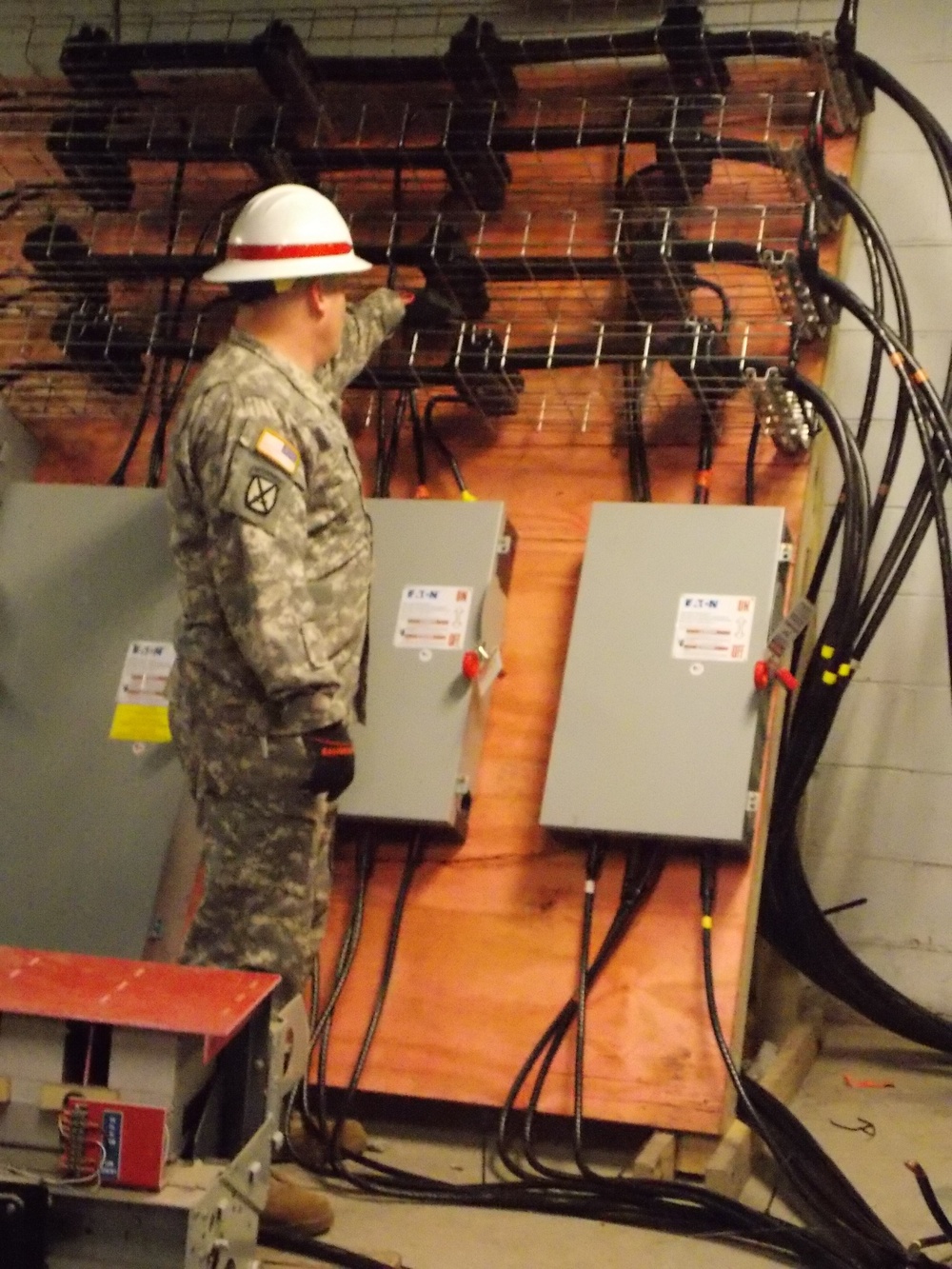 A member of the 249th Engineer Battalion inspects connections
