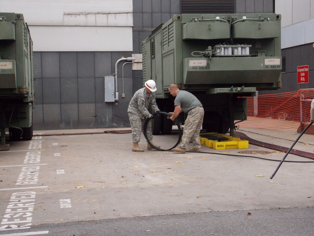 249th Engineer Battalion unrolls the generator fuel lines preparing for the final outage