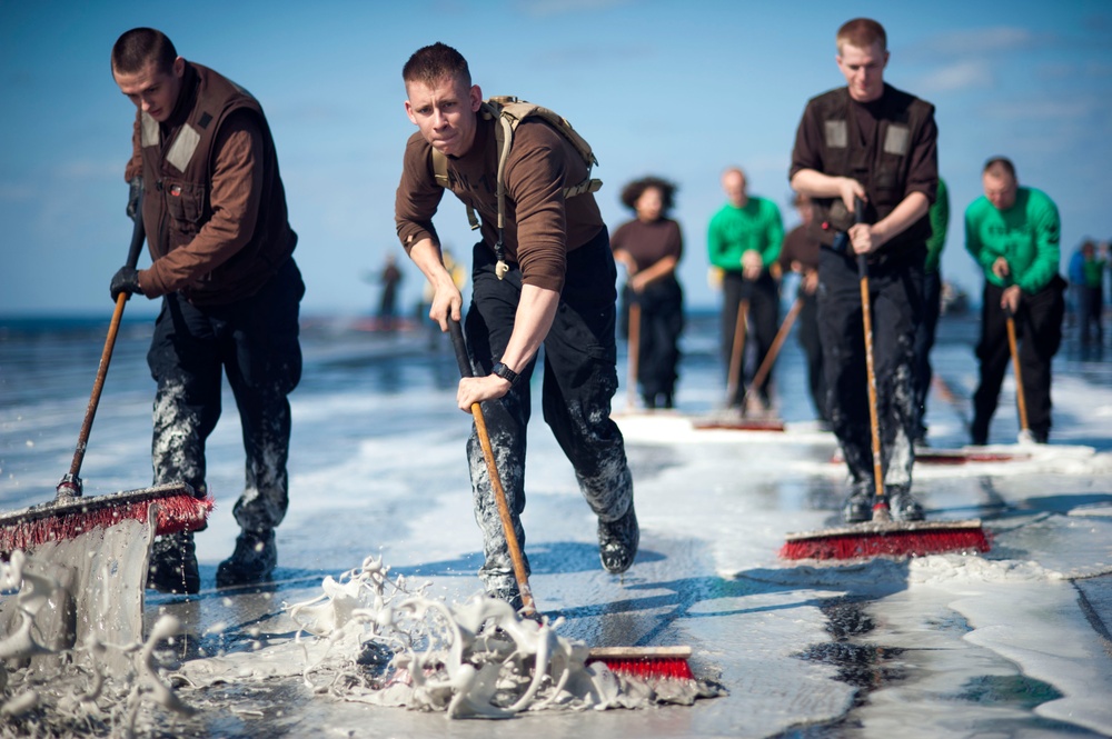 USS Harry S. Truman sailors scrub the flight deck