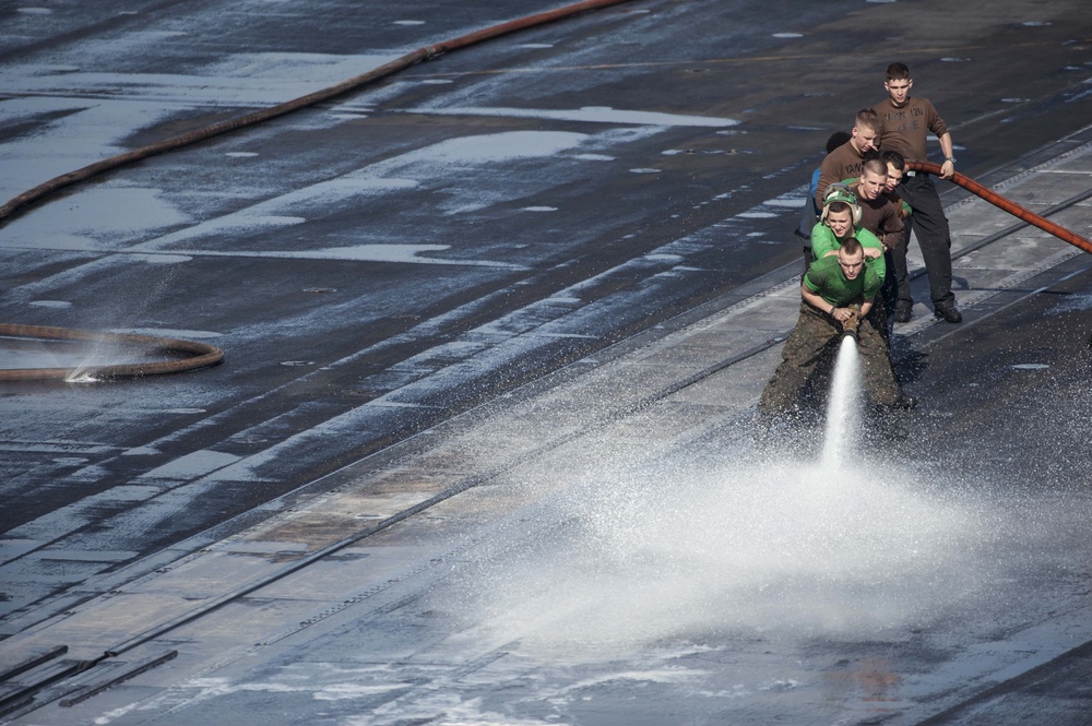 USS Harry S. Truman crew hoses flight deck