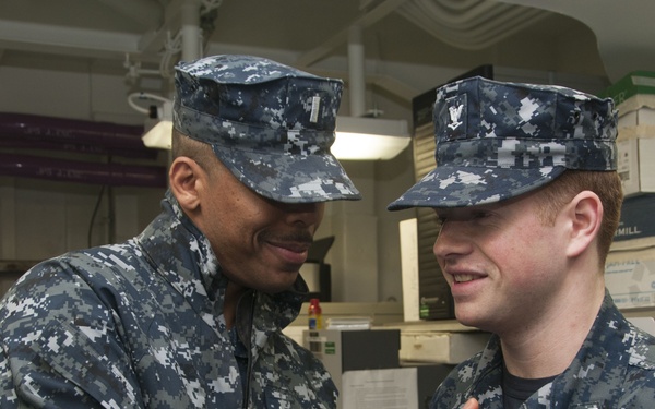 Forward-deployed mass communication specialist wears father's ESWS pin