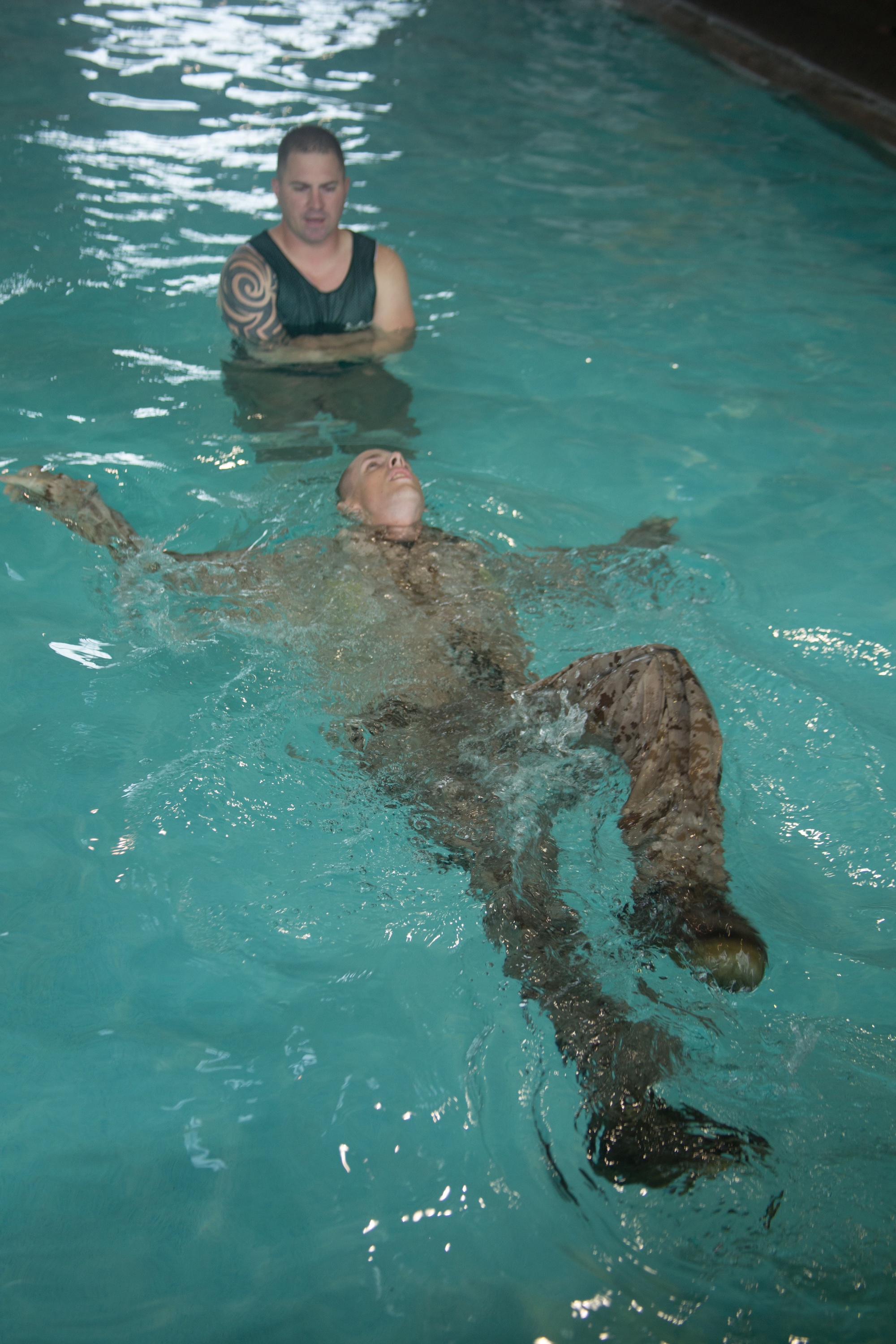 A Marine Corps Instructor of Water Survival, drill instructor, Support  Battalion, helps recruits of Golf Company, 2nd Recruit Training Battalion,  stay afloat during the Water Survival Basic Qualification course at Marine  Corps