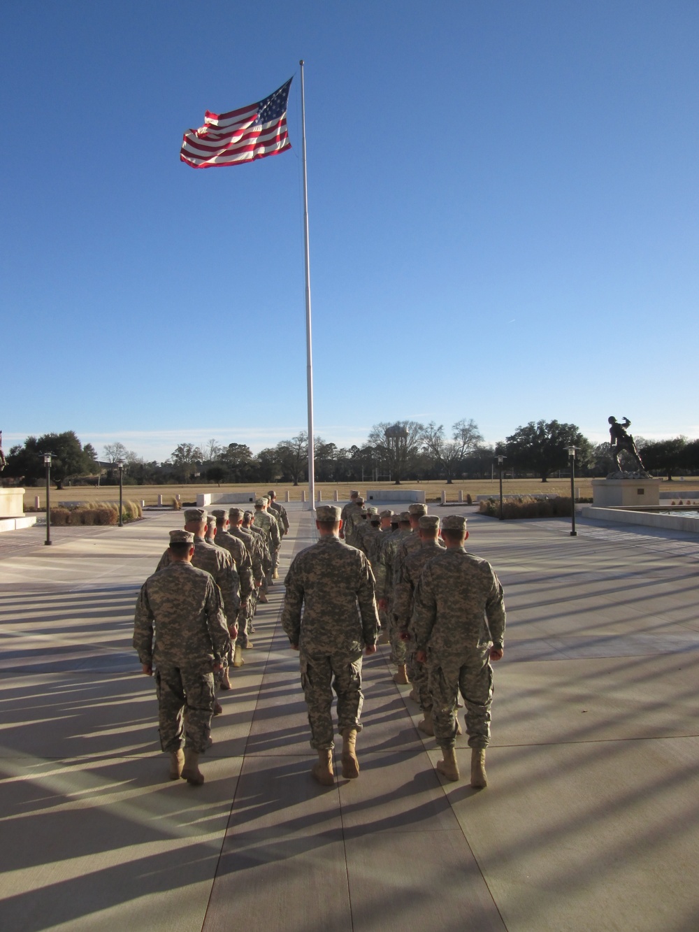 Officer candidates lower national colors at Fort Benning