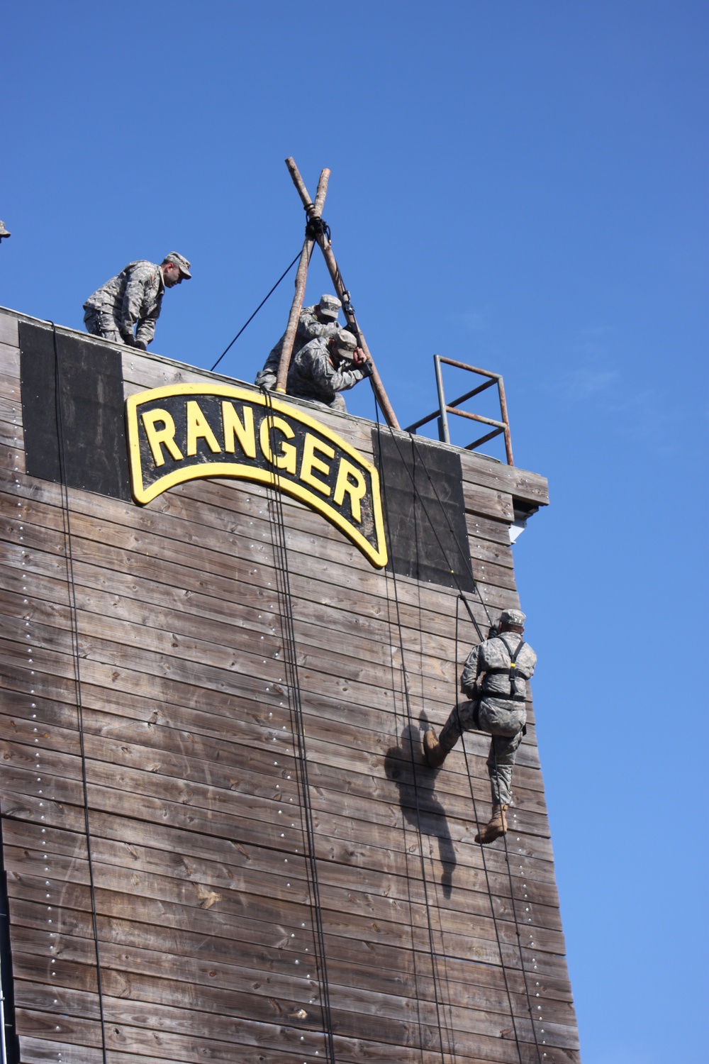 Instructors demonstrate rappel techniques during Ranger School graduation