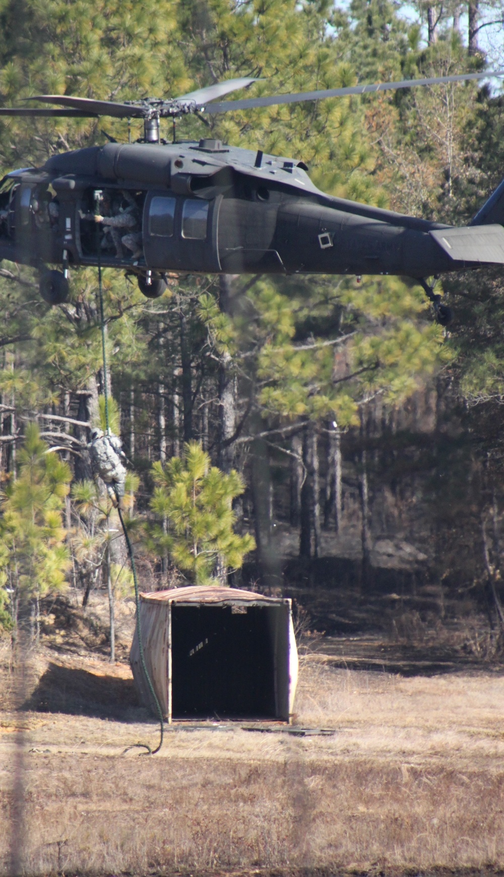 Instructors demonstrate fast rope insertion from UH-60 Black Hawk during Ranger School graduation