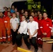 Rescuers pose with survivors after returning to port