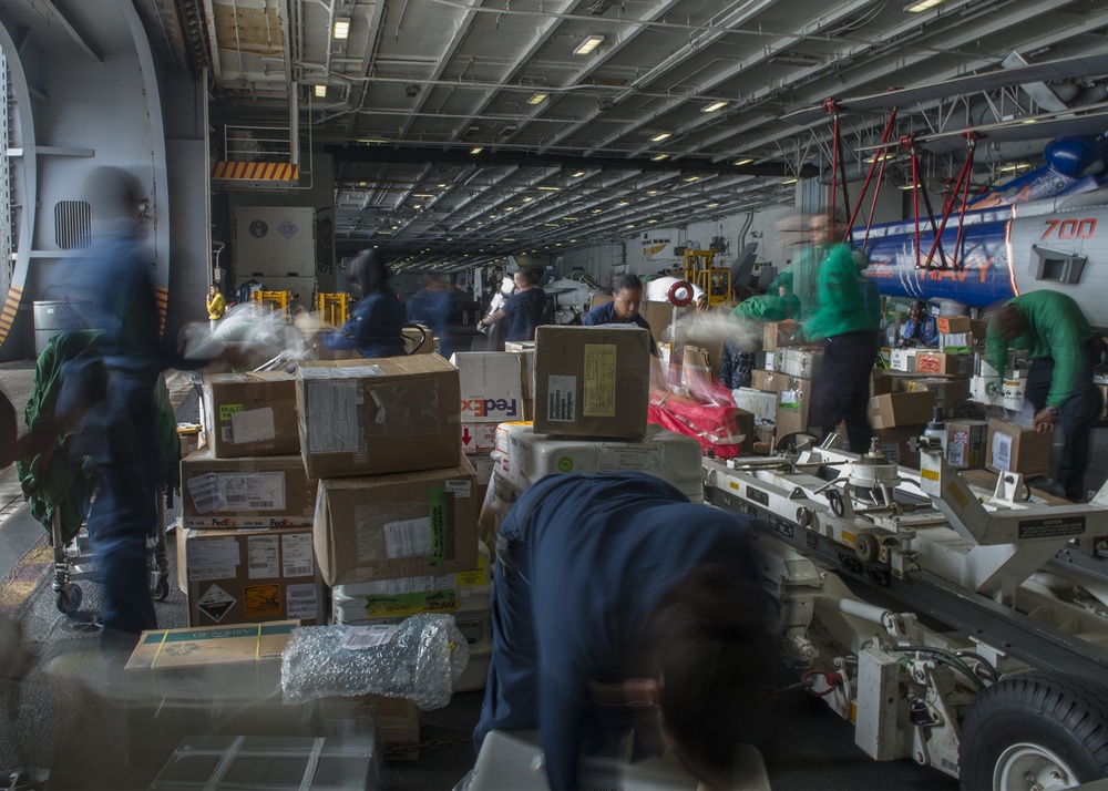 USS Harry S. Truman service members sort mail