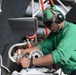 USS Harry S. Truman sailor performs helicopter maintenance