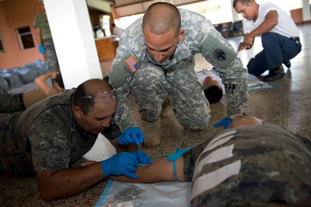 Guatemalan army soldiers practice inserting peripheral cannula
