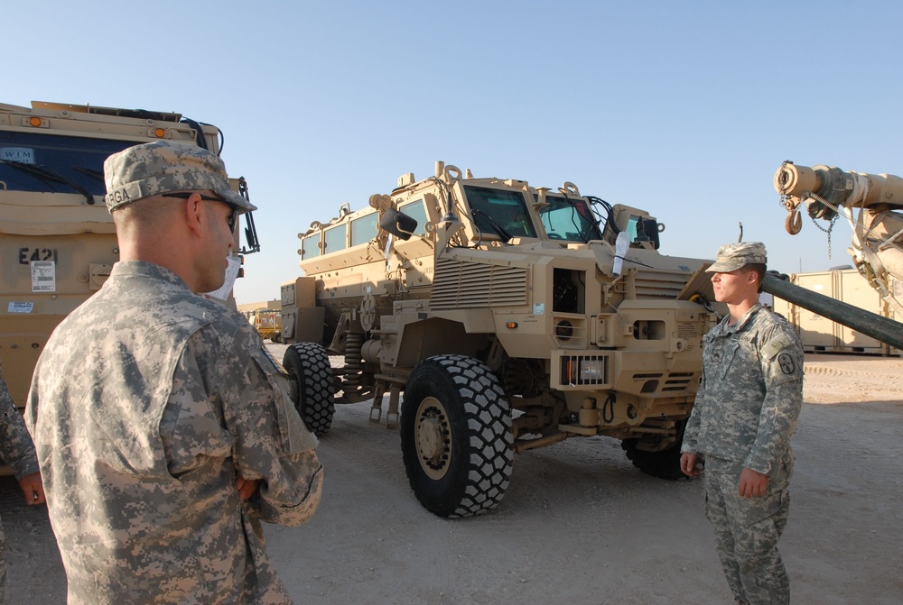Command Sgt. Maj. Barja of the 371st Sus. Bde. tours cargo operations in Southwest Asia.