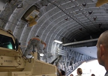 Command Sgt. Maj. Barja of the 371st Sus. Bde. tours cargo operations in Southwest Asia.