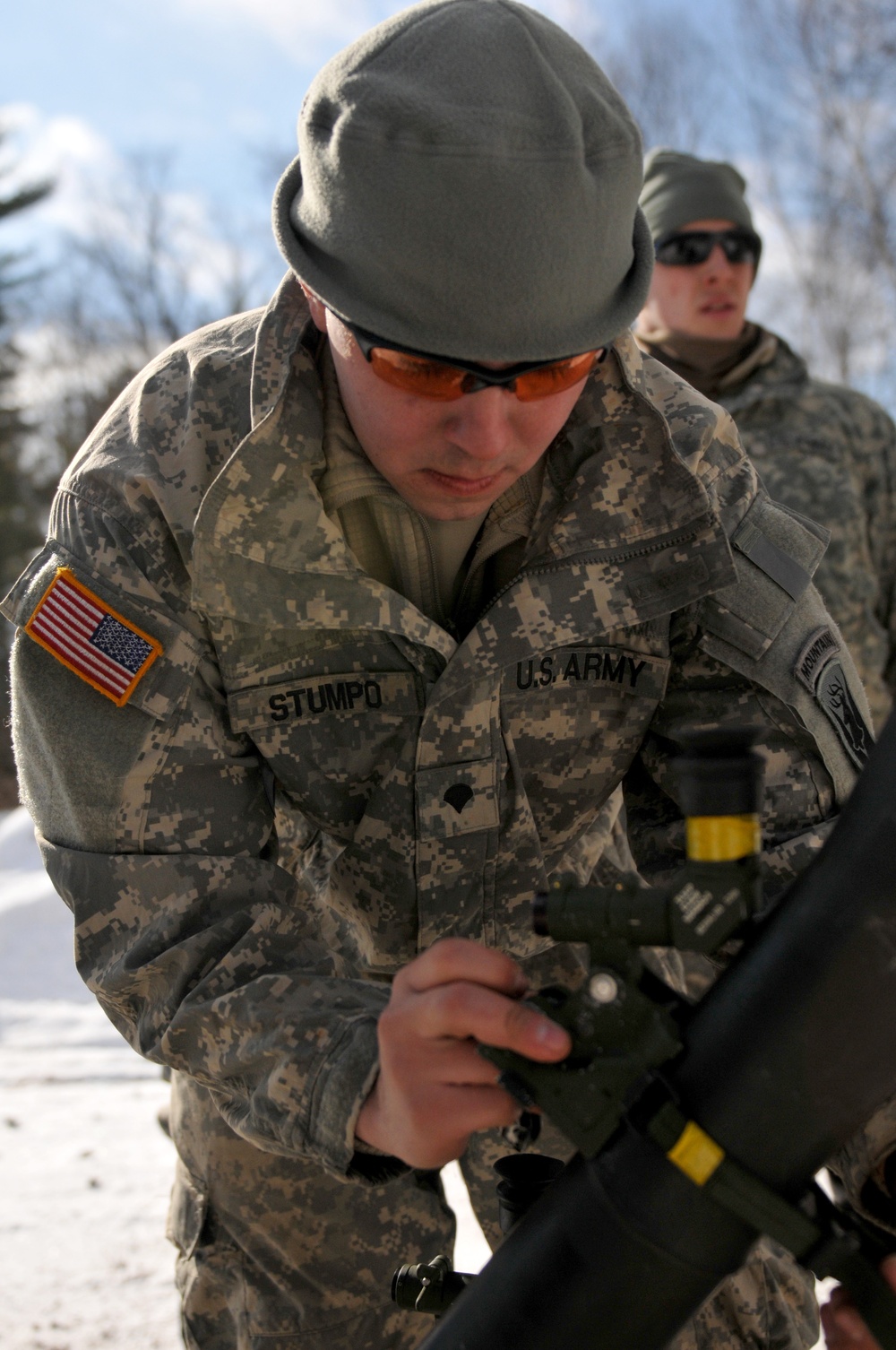 Spc. Dante Stumpo attaches a 81mm sight