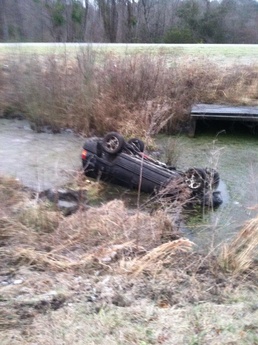 Police officer rescues overturned motorist in winter weather car accident