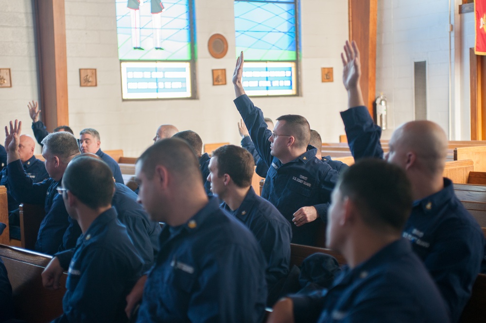 Coast Guardsmen raise their hands with questions
