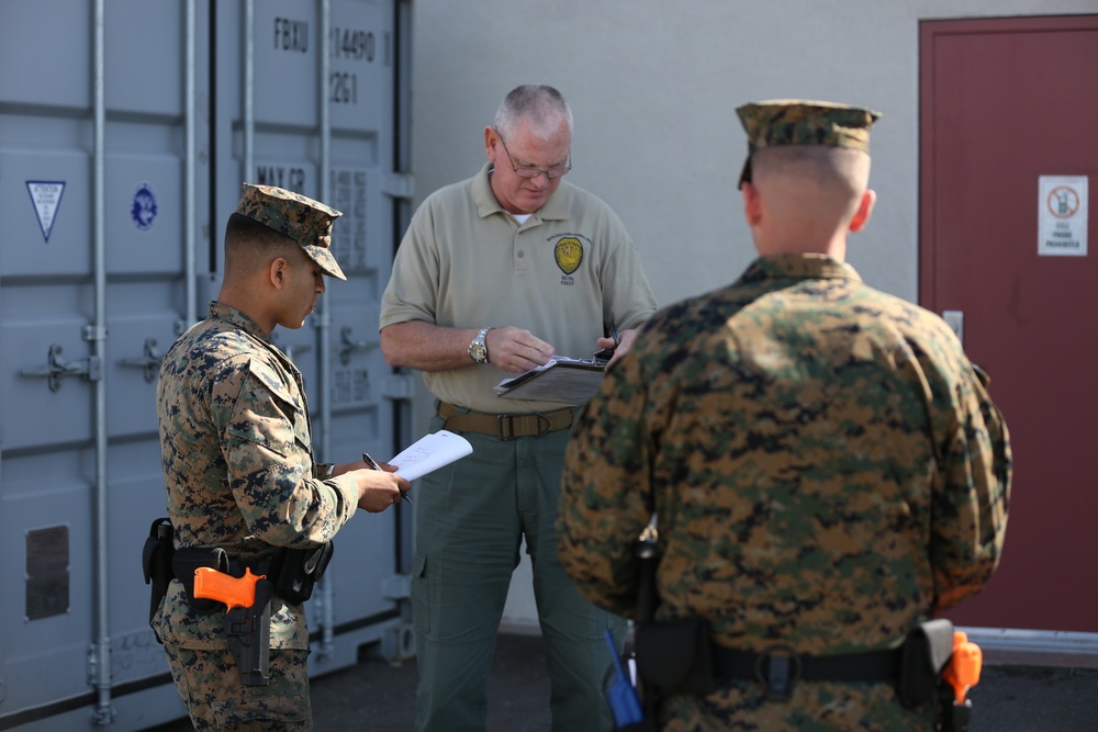 Military police work alongside civilian police aboard air station