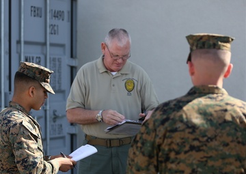 Military police work alongside civilian police aboard air station