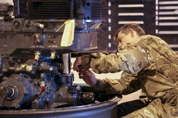 SPC Marsnix performs maintenance on the Chinook transmission
