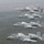 Four A-10 Thunderbolt II (Warthog) aircraft fly in a diagonal echelon formation over a forested landscape. The aircraft bear Arkansas Air National Guard markings, with 'FS' tail codes and the Arkansas state flag diamond insignia visible on the tail fins. The closest aircraft is named 'Fort Smith' and belongs to the 188th Fighter Wing.