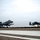Two A-10 Thunderbolt II (Warthog) aircraft are captured simultaneously taking off or landing on a military airfield runway under overcast skies. Both aircraft have their landing gear deployed and appear to be at low altitude just above the runway surface. The image was taken from ground level, providing a dramatic perspective of the twin-engine attack jets.