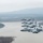 Four A-10 Thunderbolt II (Warthog) aircraft fly in a tight echelon formation over a river valley with forested terrain and mountains in the background. The aircraft display U.S. Air Force markings, 'FS' tail codes, and at least one bears the name 'Fort Smith,' suggesting assignment to the 188th Wing, Arkansas Air National Guard. The overcast sky and muted tones give the image a hazy, wintry appearance.