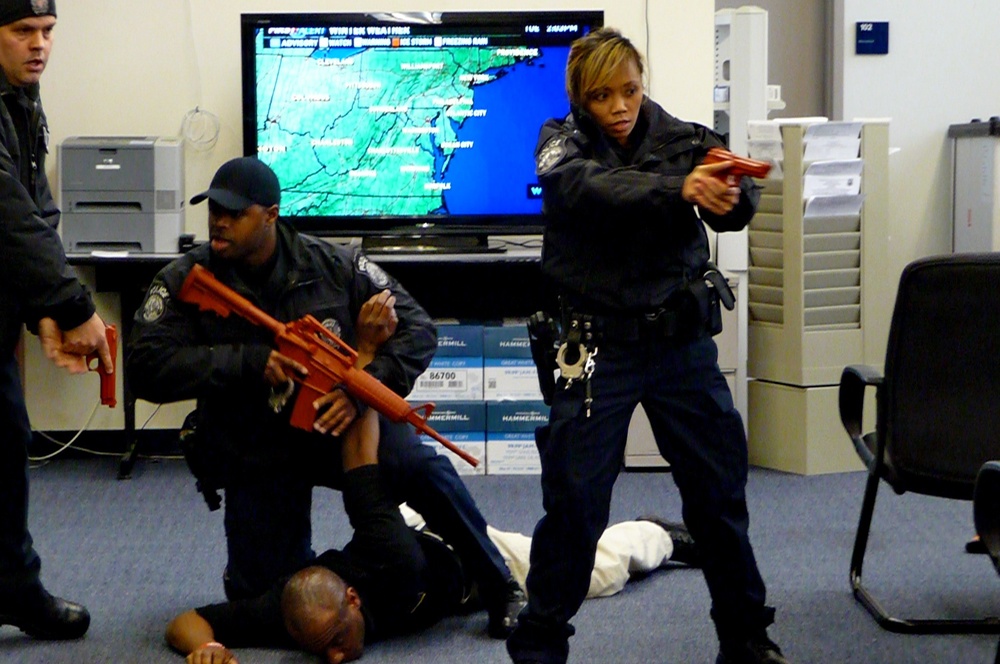 DOD police officers at Joint Base Anacostia-Bolling hold a gunman to the ground and secure an office area