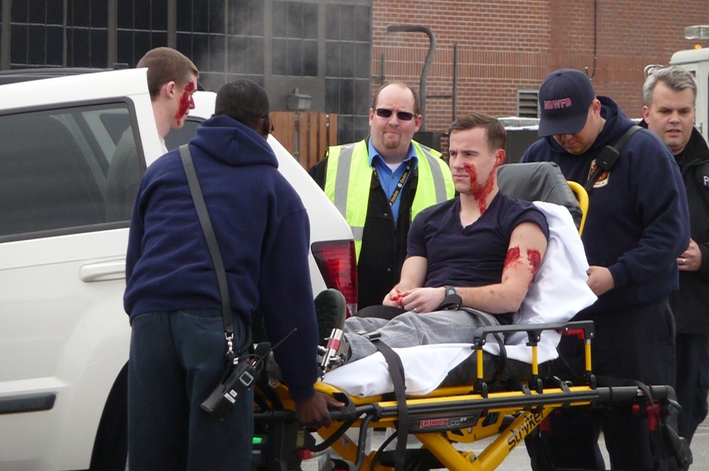 An simulated injured gunshot victim being taken to a Fire and Emergency Services paramedic unit for transport to a trauma center