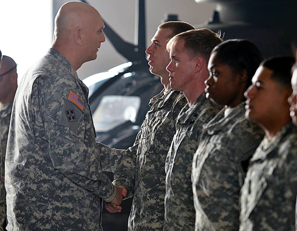 Odierno presents coins to soldiers