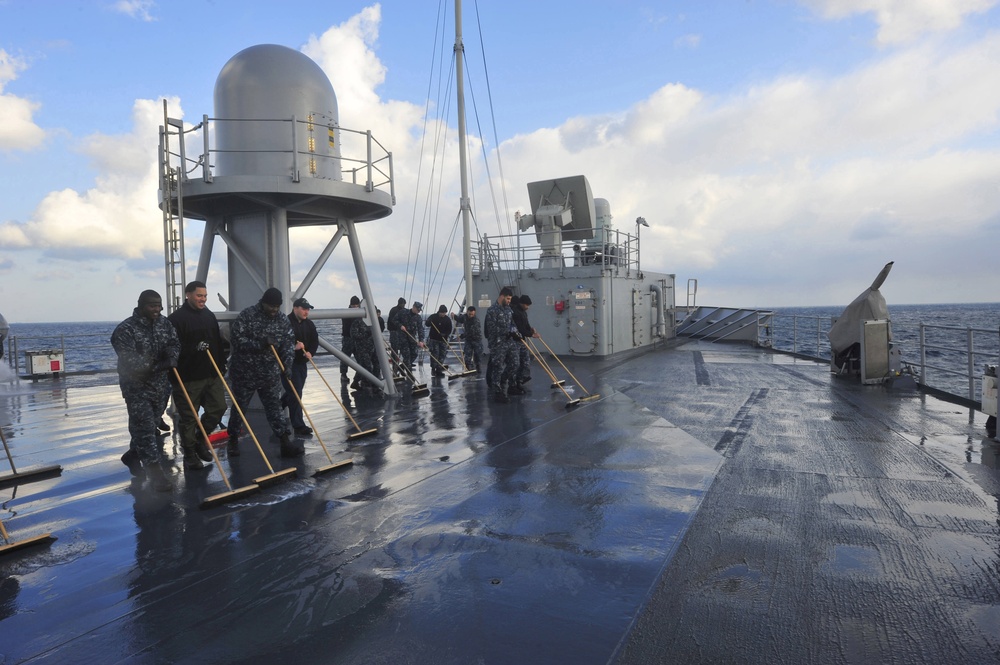 Sailors swab USS Blue Ridge's main deck