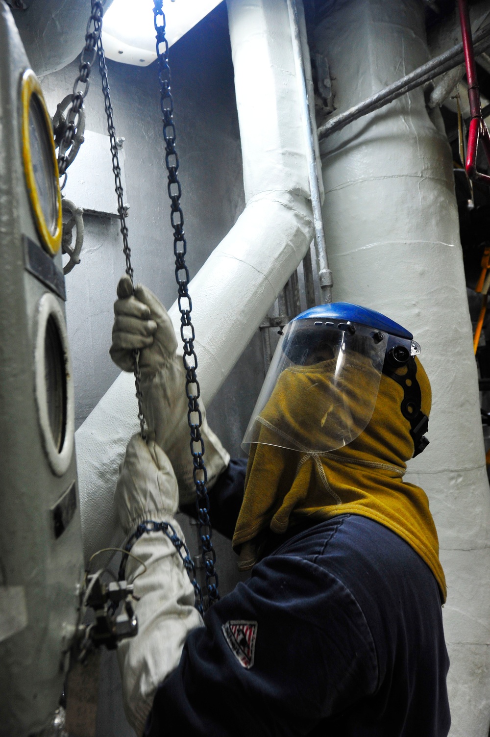 USS Blue Ridge sailor clears soot from boilers