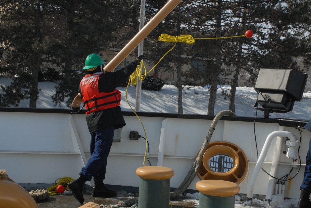 Coast Guard Cutter Hollyhock crew member helps with mooring