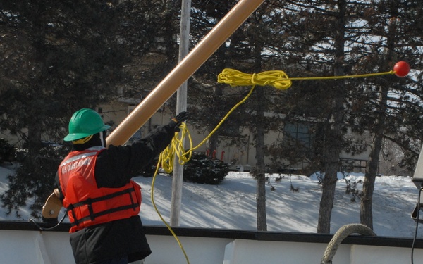 Coast Guard Cutter Hollyhock crew member helps with mooring