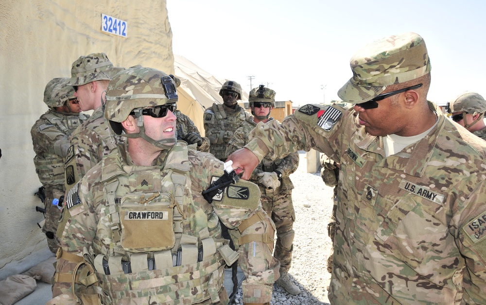 Senior medic checks soldier's tourniquet