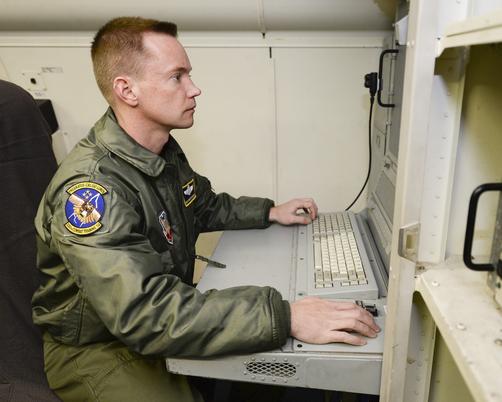 461st Air Control Wing communications system technician works aboard an E-8C Joint STARS