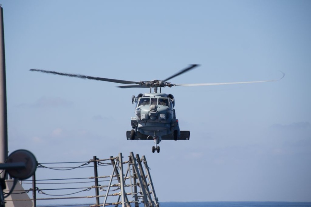 SH-60R Seahawk helicopter departs to aid in the search efforts of the missing Malaysia Airlines flight MH370
