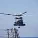 SH-60R Seahawk helicopter departs to aid in the search efforts of the missing Malaysia Airlines flight MH370