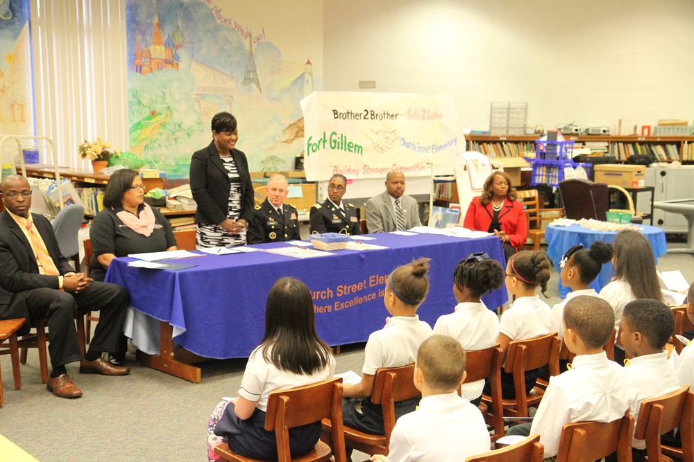 Elementary principal speaks to students, parents, faculty and soldiers during community partnership