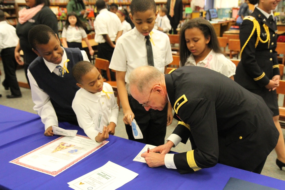 Students eagerly wait for an autograph from brigadier general