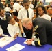 Students eagerly wait for an autograph from brigadier general